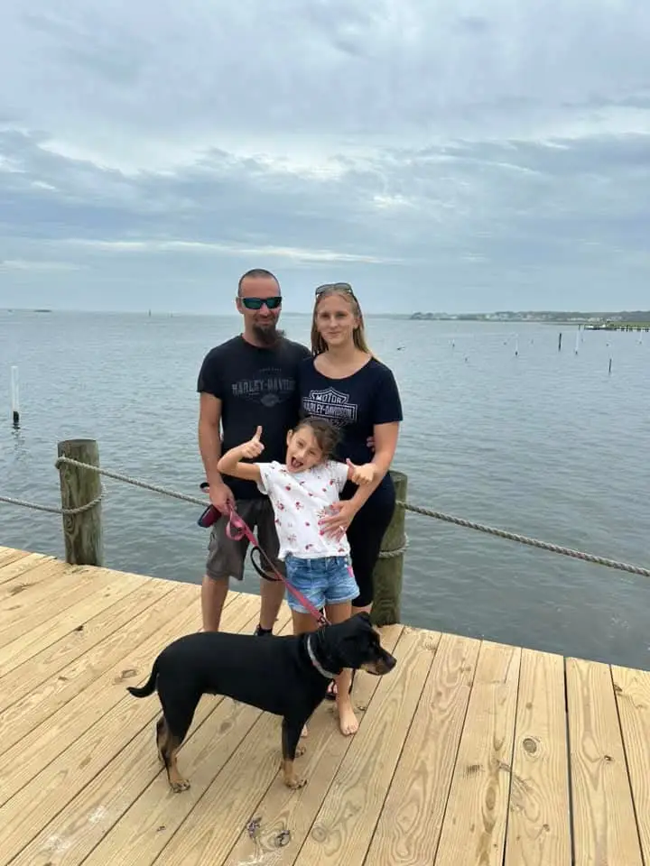 Brad Smith, owner of Keep Them Rolling Trailer Repair, with his family and dog on a dock