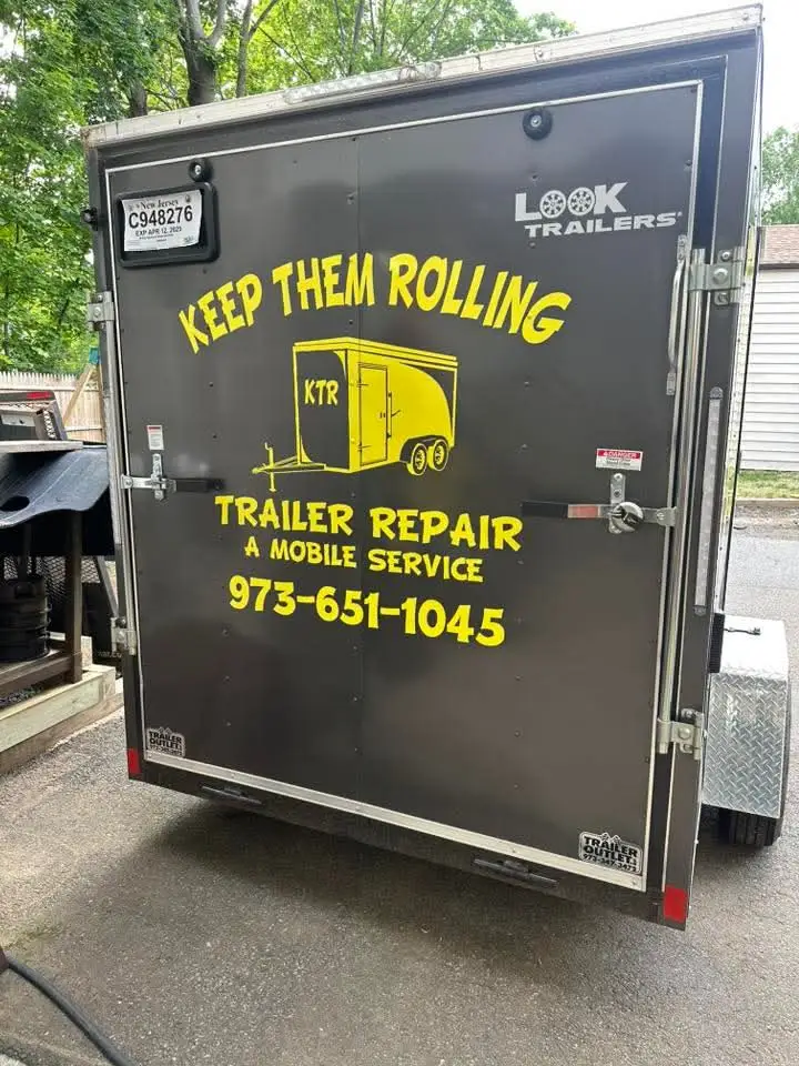 Rear doors of the Keep Them Rolling branded enclosed service trailer