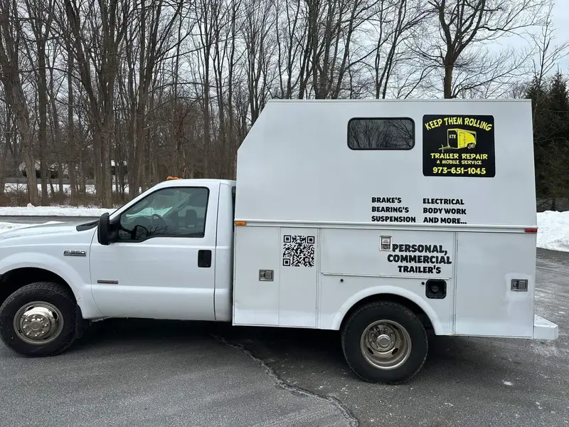 Keep Them Rolling white utility-body service truck with the KTR logo and phone number